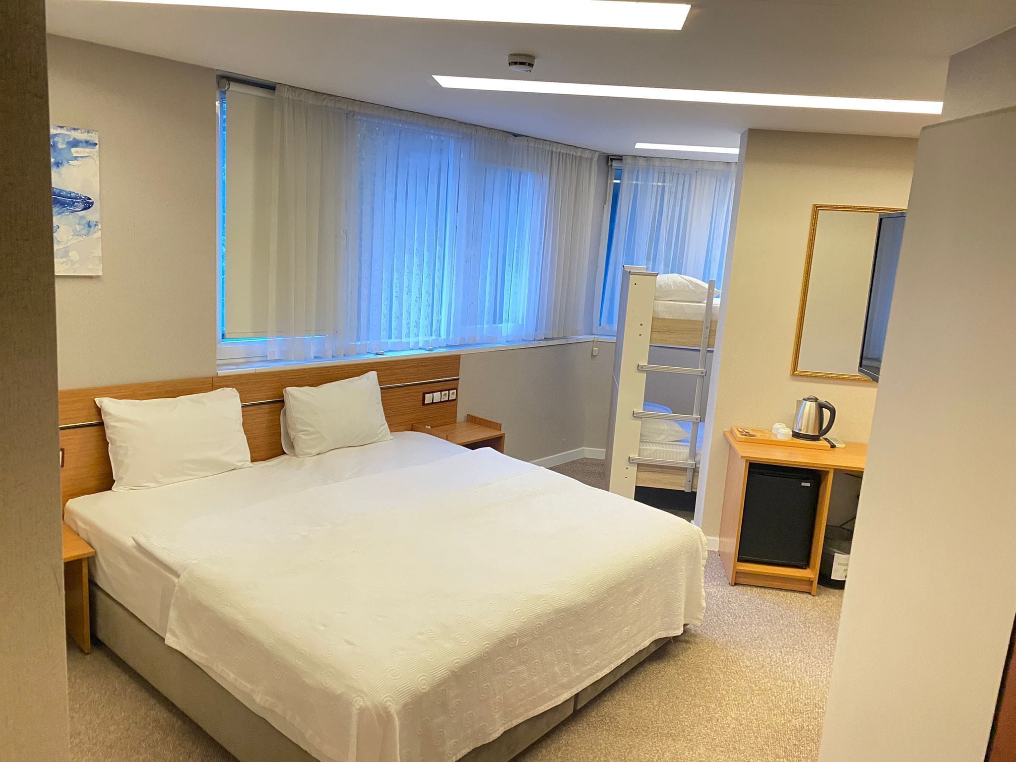 Family Quadruple Room | Minibar, in-room safe, desk, laptop workspace