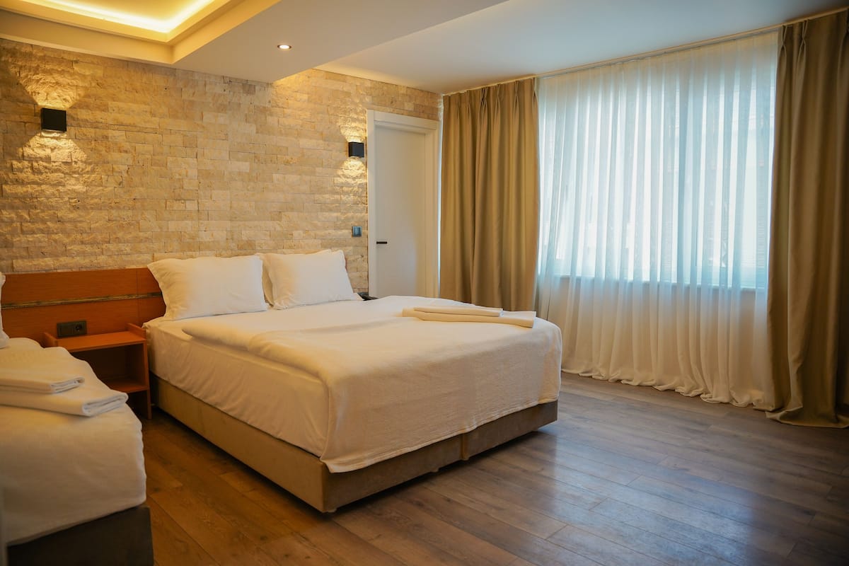 Deluxe Quadruple Room | Minibar, in-room safe, laptop workspace, free WiFi