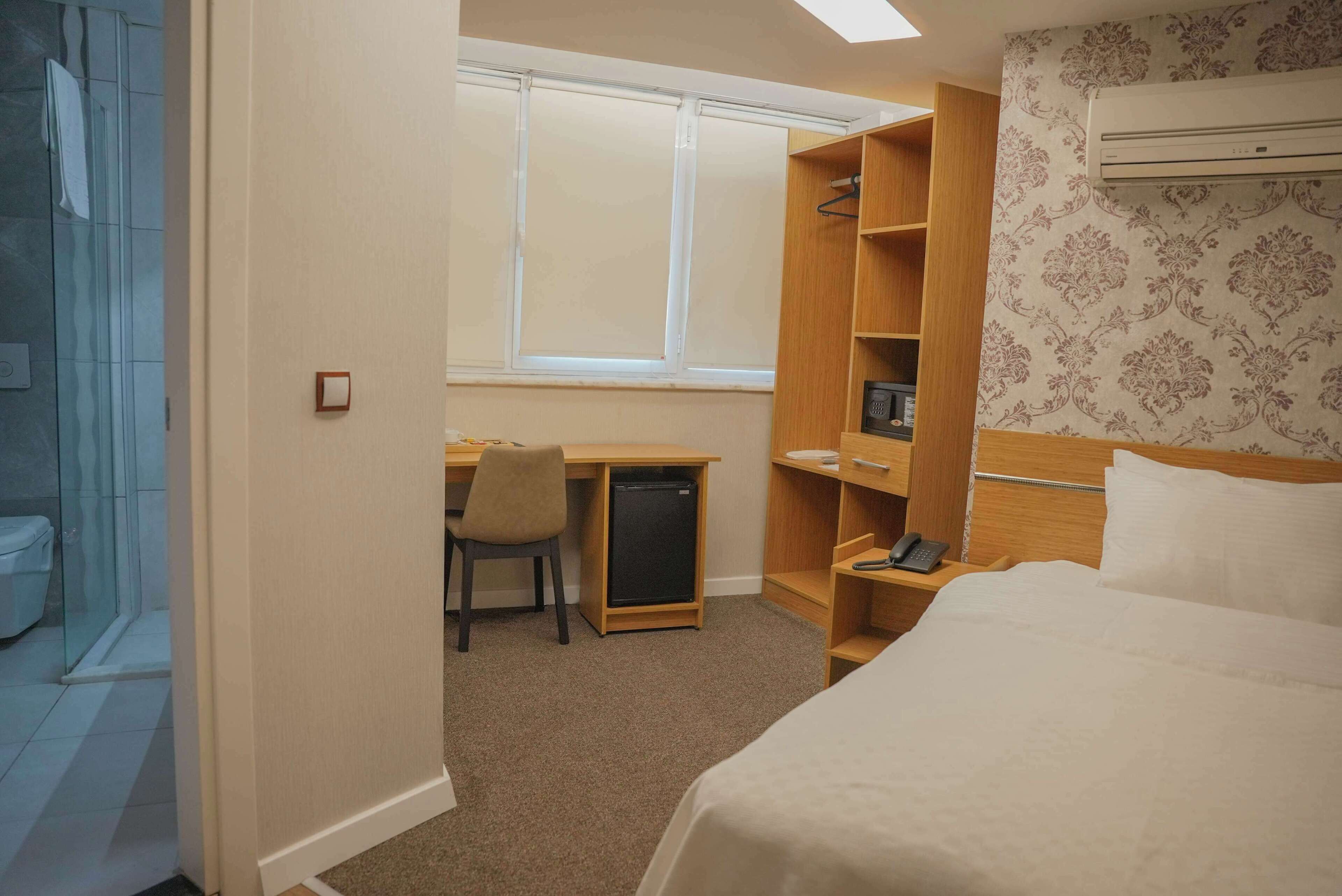 Economy Room, City View | Minibar, in-room safe, desk, laptop workspace