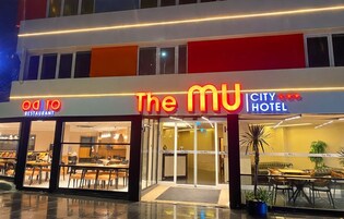 Un hotel con restaurante llamado 'The MU City Hotel' y una entrada visible.