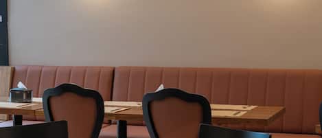 A restaurant interior with booths, tables, and chairs.