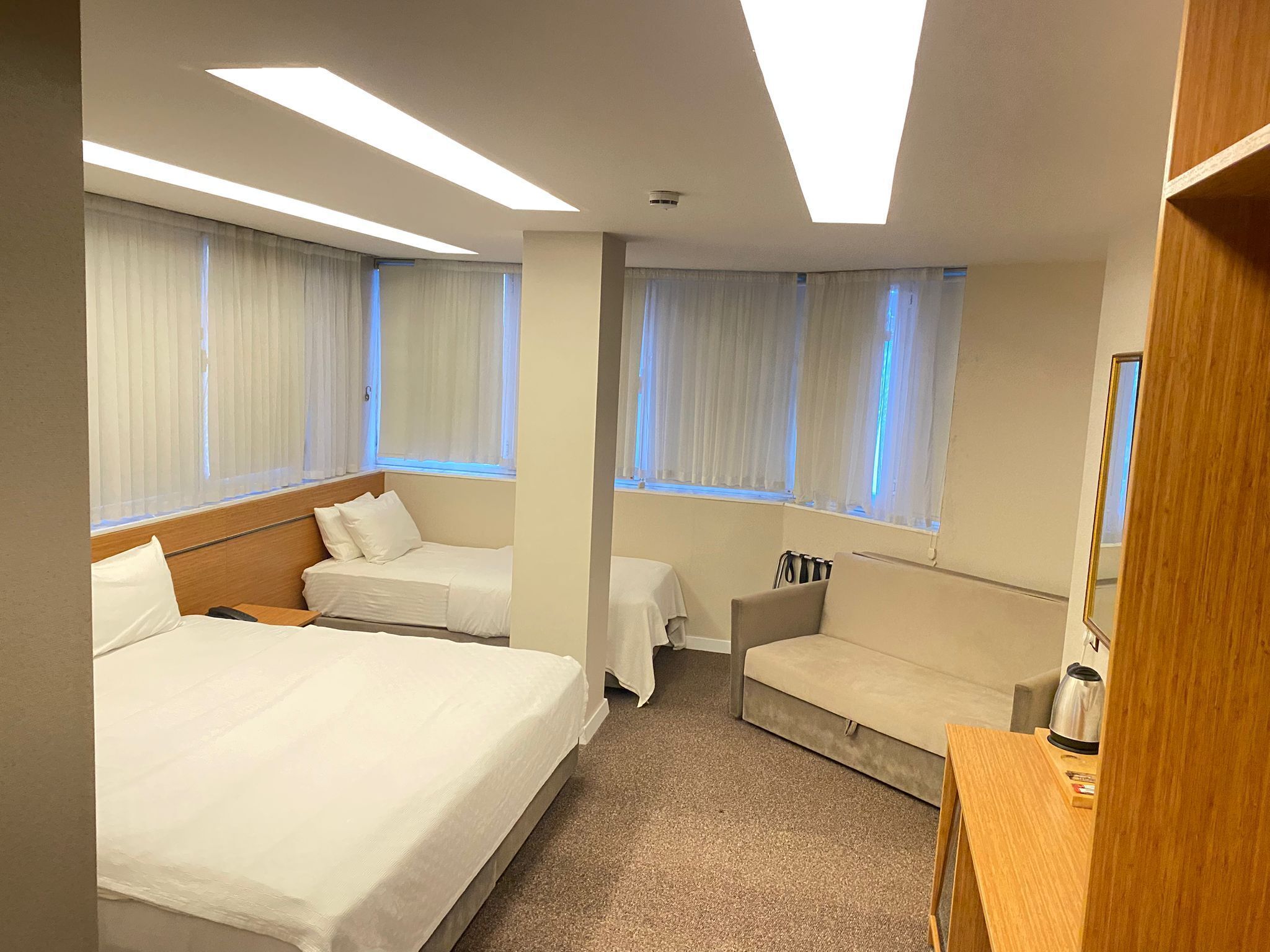 Deluxe Quadruple Room | Minibar, in-room safe, desk, laptop workspace