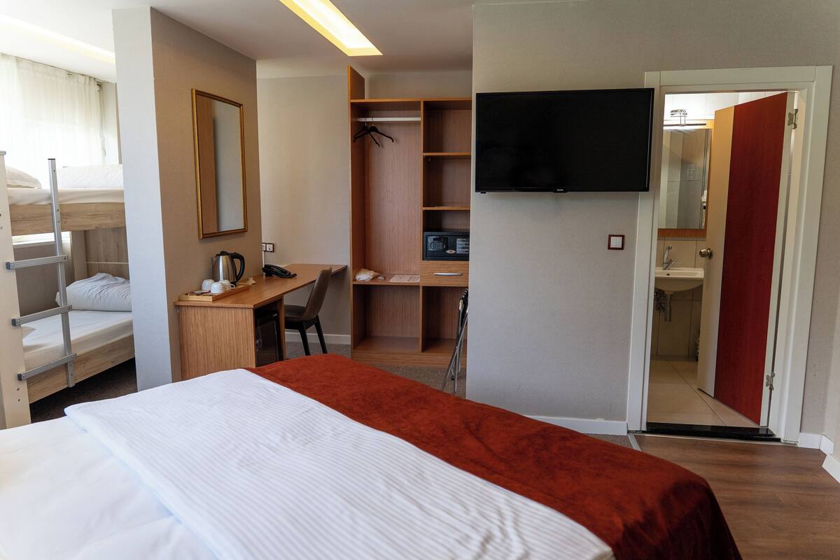 Family Quadruple Room | Minibar, in-room safe, desk, laptop workspace