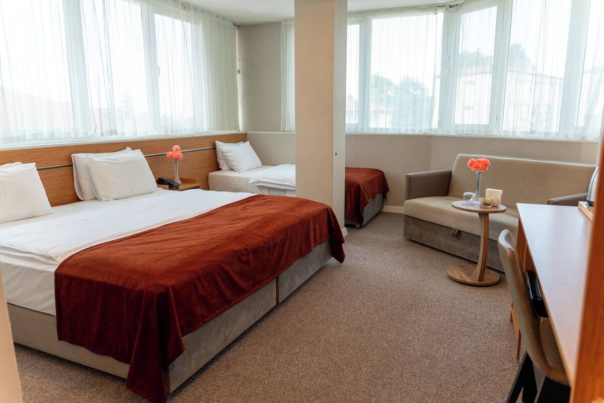 Deluxe Quadruple Room | Minibar, in-room safe, desk, laptop workspace