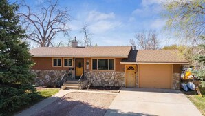 A single-story house with a stone foundation and a brown roof. - Charming 2-bedroom apartment with WiFi, AC in fabulous Rapid City (Rapid City)