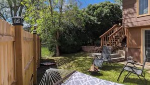 A wooden house with a porch, a hammock, and a grassy yard. - Charming 2-bedroom apartment with WiFi, AC in fabulous Rapid City (Rapid City)