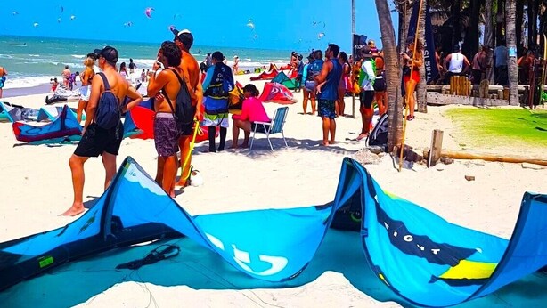 A beach with people, tents, and a clear sky.