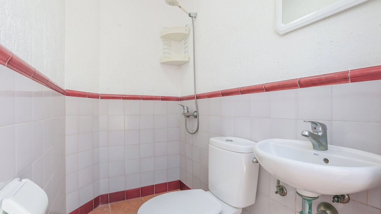 A small bathroom with a toilet, bidet, and sink.