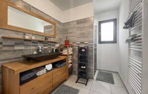 A modern bathroom with a wooden vanity, a large mirror, tiled walls, a towel rack, and a window. - Stunning home in St-Florent-sur-Auzonne (St-Florent-sur-Auzonne)