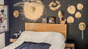 A bedroom with a bed, a wooden headboard, a wall-mounted hat rack, and a framed picture. - Lovely home in Saint-Césaire-de-Gauzi with WiFi (Saint-Césaire-de-Gauzi)