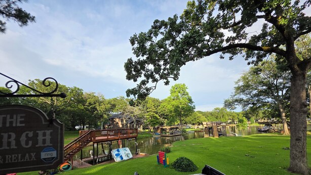 A hot tub in a grassy area with a wooden deck and a sign that reads "The Church Relax". - Lakefront, Boat dock, Fishing, Fire pit, Kayak, pedal boat, Paddle board (Mabank)
