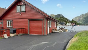 A red wooden building with a dock, a swing, and a view of boats on the water. - 2 bedroom lovely home in Erfjord (Erfjord)