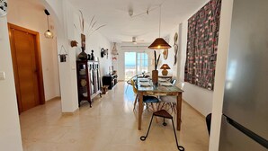A spacious hallway with a dining area, a view to the outside, and a patterned wall. - AP418 VILLA MARIVI (Torrox)
