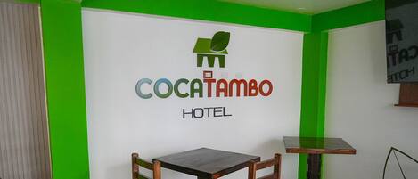 A hotel sign with the name 'Cocatambo Hotel' and a logo above it.
