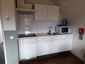 Fridge, microwave, coffee/tea maker, cookware/dishes/utensils