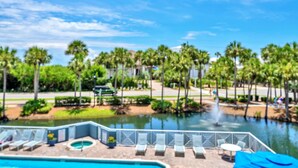 A pool area with lounge chairs and a water feature.