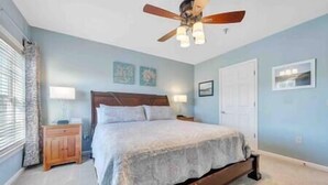 A bedroom with a bed, a nightstand, a ceiling fan, and a door. - Spacious 1 king bedroom WiFi on-site restaurant (Moneta)