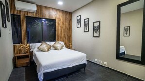 A modern bedroom with a large bed, wooden paneling, and artwork on the walls. - 6 Bedoom Apartment with Balcony, Pool tableJacuzzi (Medellín)