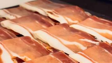A tray of sliced cured meat.