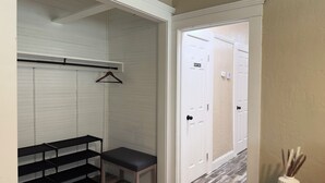 A hallway with a bench, a coat rack, and a 'Staff Only' door. - Sequoia Escape 3BR Home w/ King Bed & In-Unit Laundry (Visalia)