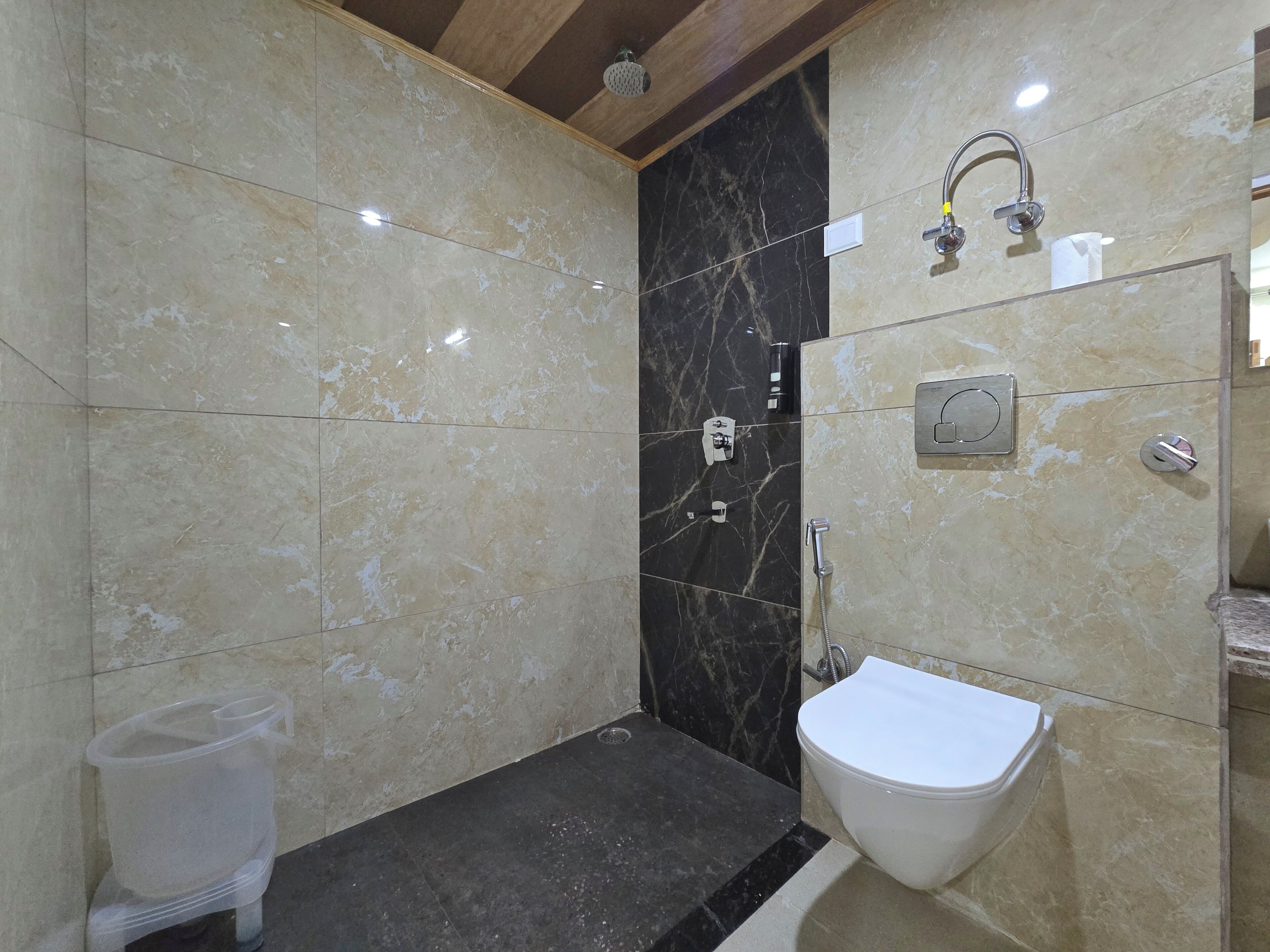 A bathroom with a shower, toilet, and sink.