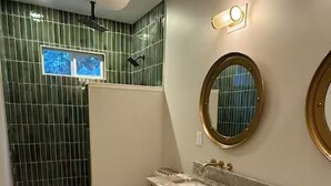 A bathroom with a shower, toilet, vanity with a marble countertop, and a large mirror. - In-Town Lewes, Private Getaway! 4 BDRM,2.5BA. Steps to 2nd Street and Bike Trail (Lewes)