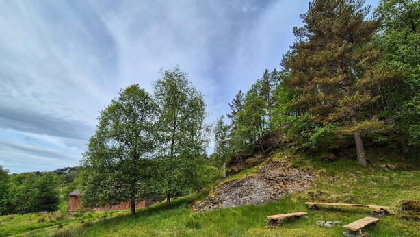 A rural landscape with a wooden structure, possibly a shed, surrounded by trees and grassy terrain. - 7 bedroom amazing home in Nedre Vats (Nedre Vats)
