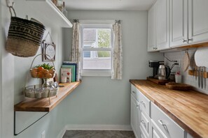 Fridge, microwave, coffee/tea maker, cookware/dishes/utensils