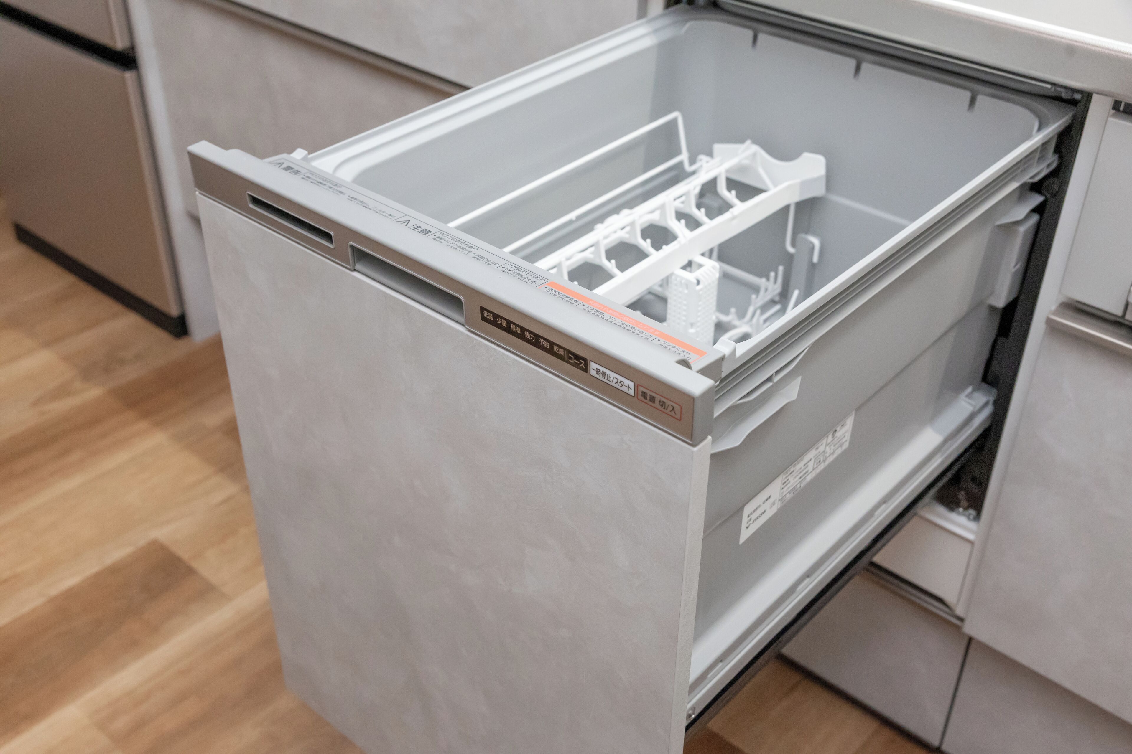 Una cucina moderna con lavastoviglie integrata e frigorifero in acciaio inossidabile.