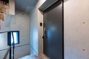 A modern elevator with a metallic door and a small window at the top. - Less than 10 minutes from each of Shibuya, Shinjuku and Harajuku/ Central location/ New construction/ Max. 6 people (渋谷区)