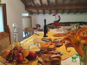 A dining table with food, drinks, and a bottle. - GrazieSole Farmhouse—entire house for exclusive use, with a view of the Sibillini Mountains (Penna San Giovanni)
