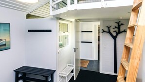 A modern loft bedroom with a bunk bed, a desk, and a ladder. - 4 Person Holiday Park Home in Karrebaeksminde (Karrebæksminde)