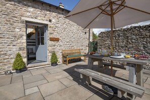 A stone building with a wooden bench and picnic table, a small potted plant, and a sign reading "Oberlander." - Ower Yonder, Ingleton (Ingleton)