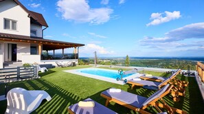 A pool with lounge chairs, a covered patio, and a view of the landscape. - Villa AD Astra by Villas Guide (Sesvete)