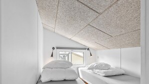 A compact room with two single beds, a window with a view, and a ceiling with a textured pattern. - 6 Person Holiday Park Home in Faaborg (Faaborg)