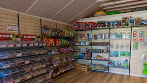 A store with shelves stocked with snacks, toys, and other items. - 6 Person Holiday Park Home in Vipperod (Vipperod)