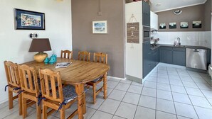 A dining area with a wooden table and chairs, a lamp, and a framed picture on the wall. - 2 bedroom lovely home in Lemmer (Lemmer)