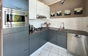 Fridge, stovetop, dishwasher, coffee/tea maker