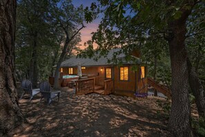 A cabin with a deck, outdoor seating, and a staircase leading to the entrance. - PET FRIENDLY! HOT TUB! Single Story!  Pool Table! (Big Bear City)