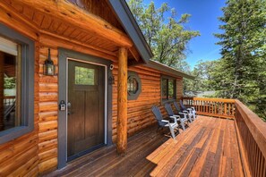 A log cabin with a deck, outdoor seating, and a door with a window. - PET FRIENDLY! HOT TUB! Single Story!  Pool Table! (Big Bear City)