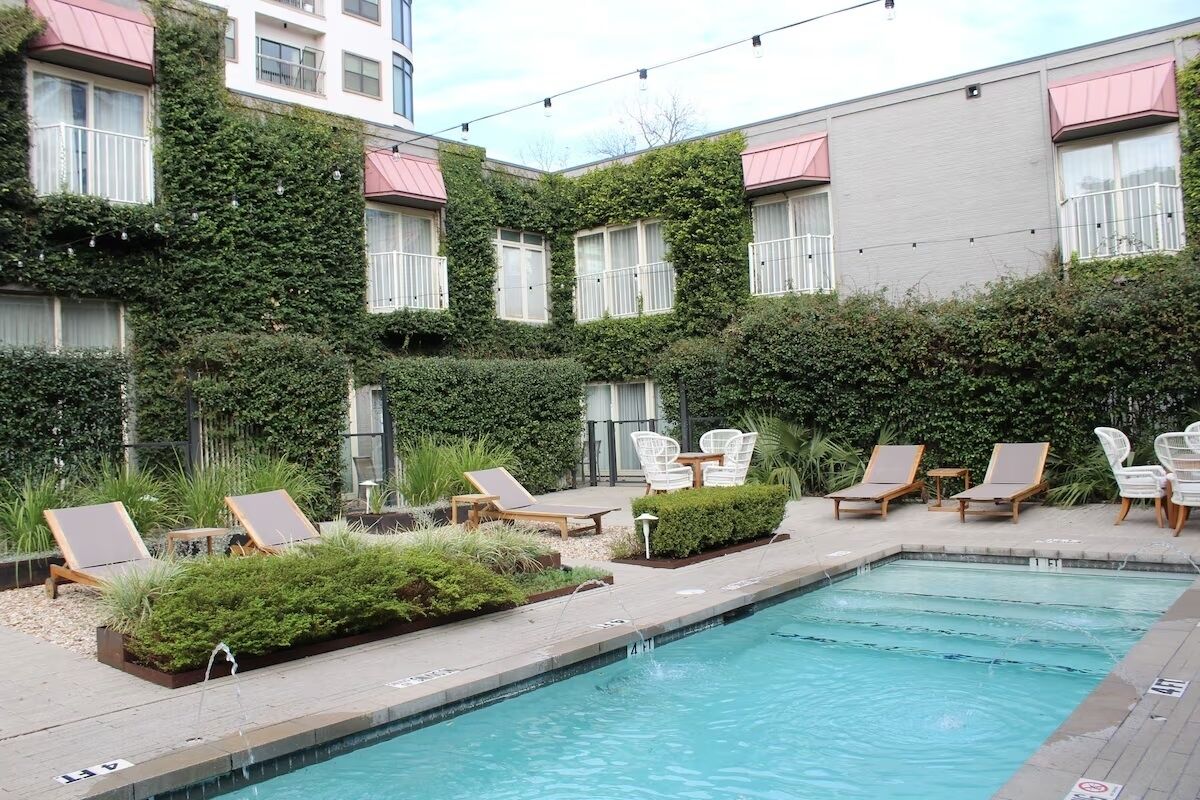 A pool area with lounge chairs and a small pool.
