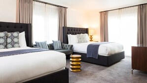 A hotel room with two beds, a sofa, a lamp, and a small side table. - Deluxe Double Queen, Hotel Ella, On-site Restaurant, Near Moody Center (Austin)