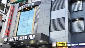 A building with a sign for "HOTEL MAX INN" and a "TEQUILA" sign on the ground floor. - Hotel Max INN (Bhagalpur)