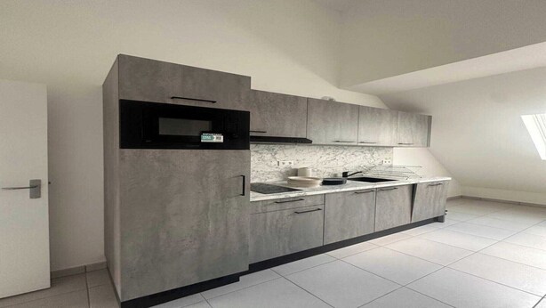 A modern kitchen with grey cabinetry, a black microwave, and a marble backsplash. - Elegant Appt - 3BDR/8P - Near Paris & La Défense (Suresnes)