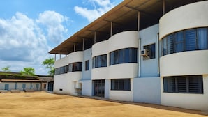 A multi-story building with a flat roof and large windows. - Hotel Sai Samrat Inn (Panvel)
