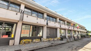 A modern building with multiple balconies, large windows, and a flat roof. - Suite A Tema (Milan)
