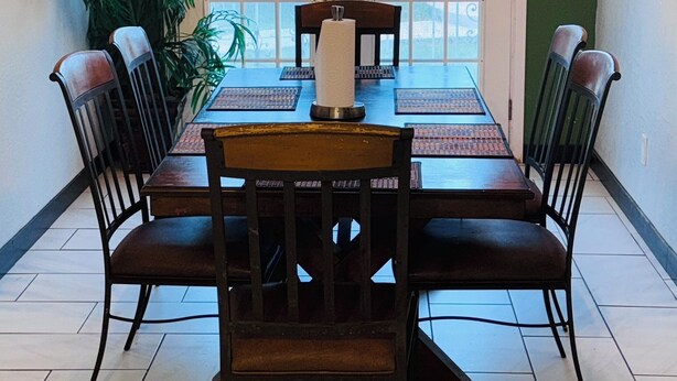 A dining area with a table and chairs, a hanging light fixture, and a view through a door. - Spacious 3-bedroom house in brilliant Austin  /The Domain & Q2 Stadium/ (Austin)