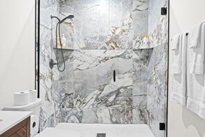 Shower, hair dryer, towels, shampoo