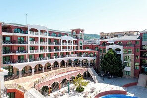 A multi-story hotel with outdoor seating areas and a swimming pool. - Saint George Palace - All Inclusive (Sveti Vlas)