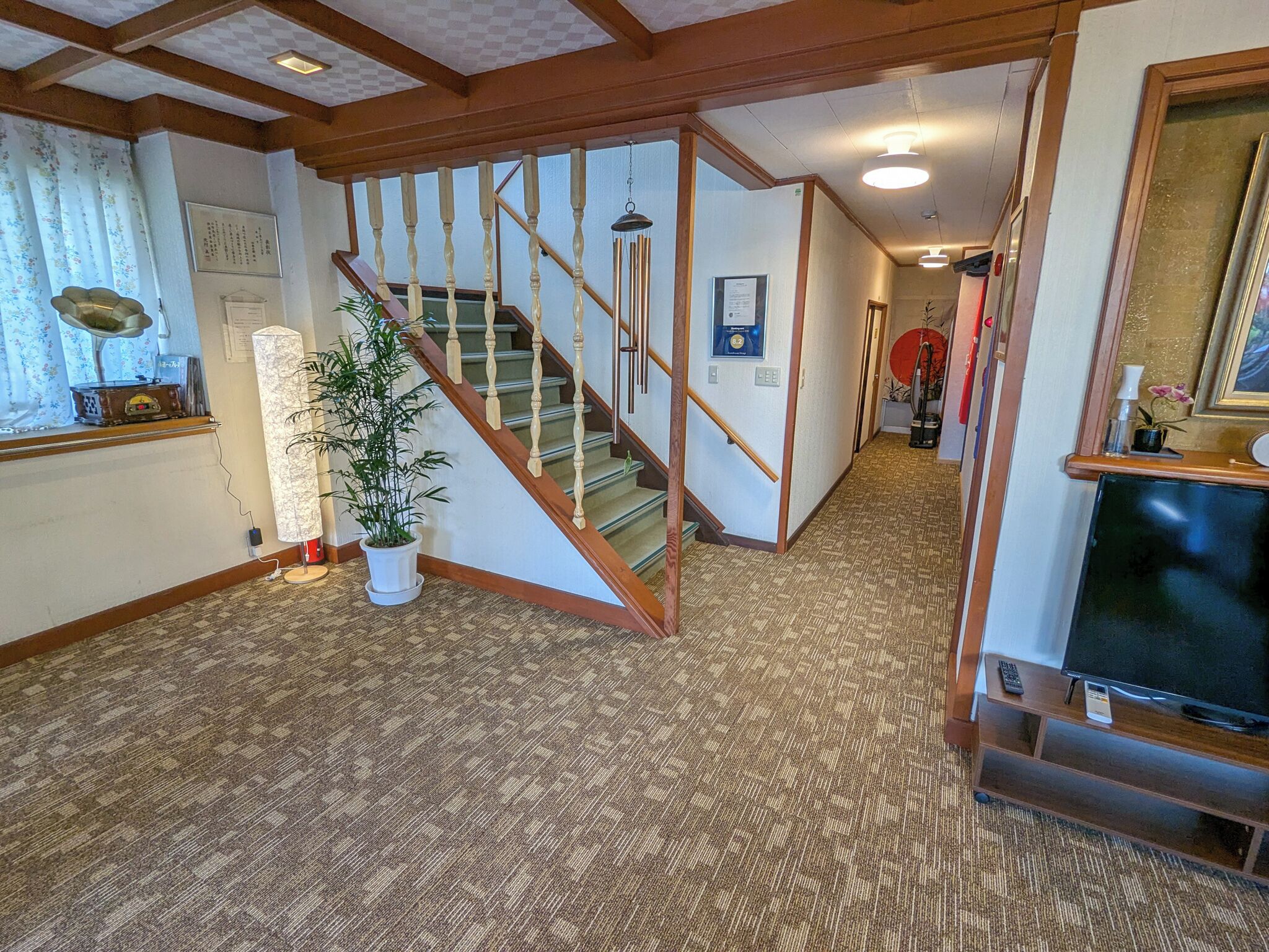 A staircase with wooden balusters and a carpeted floor.